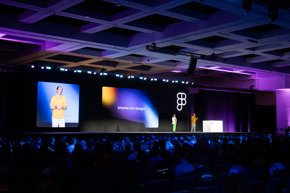 Standing on stage speaking to the notion that all of our users design their tools with a slide of 'Anyone can design' on it